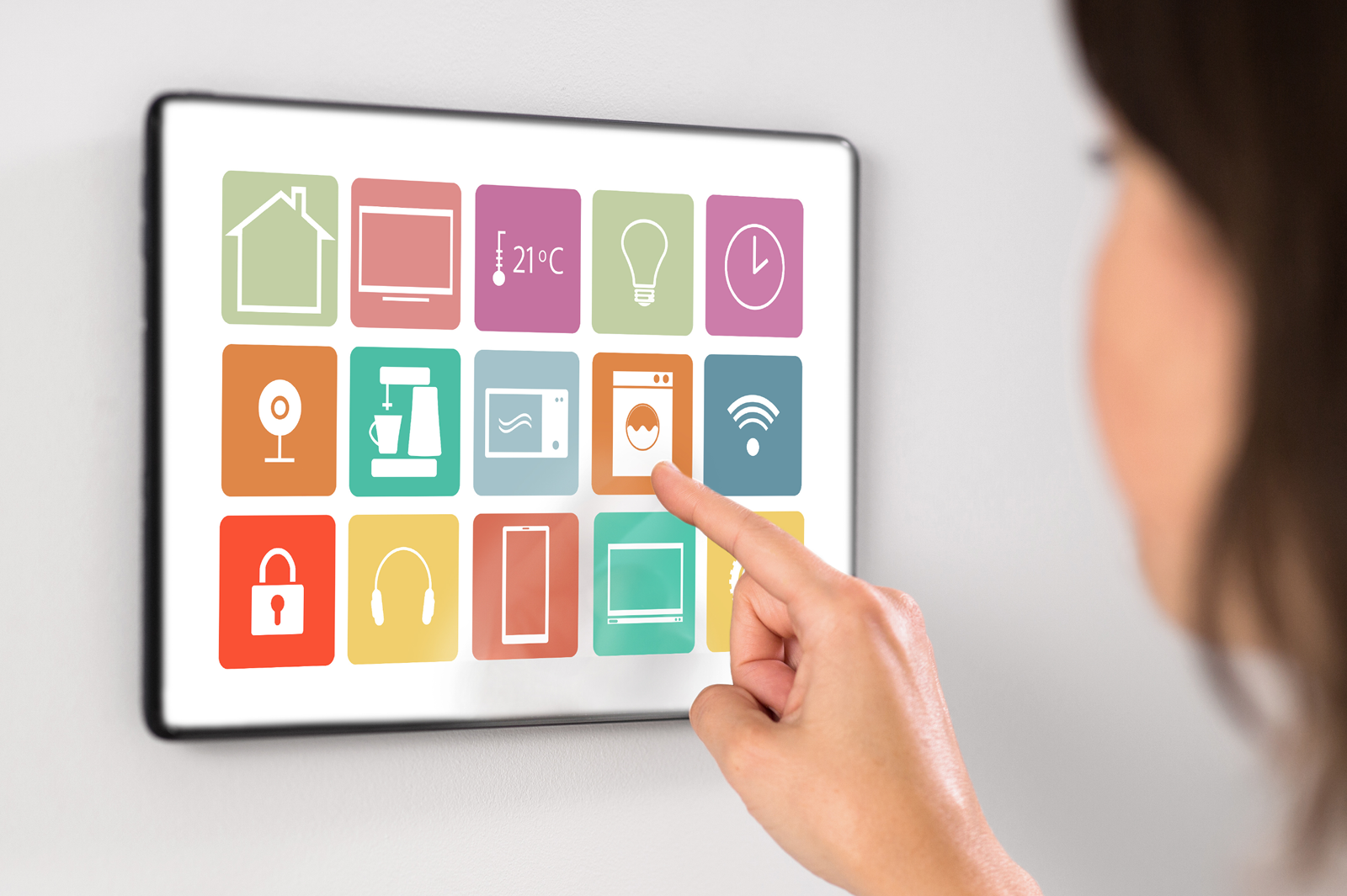 Woman using IoT device on wall