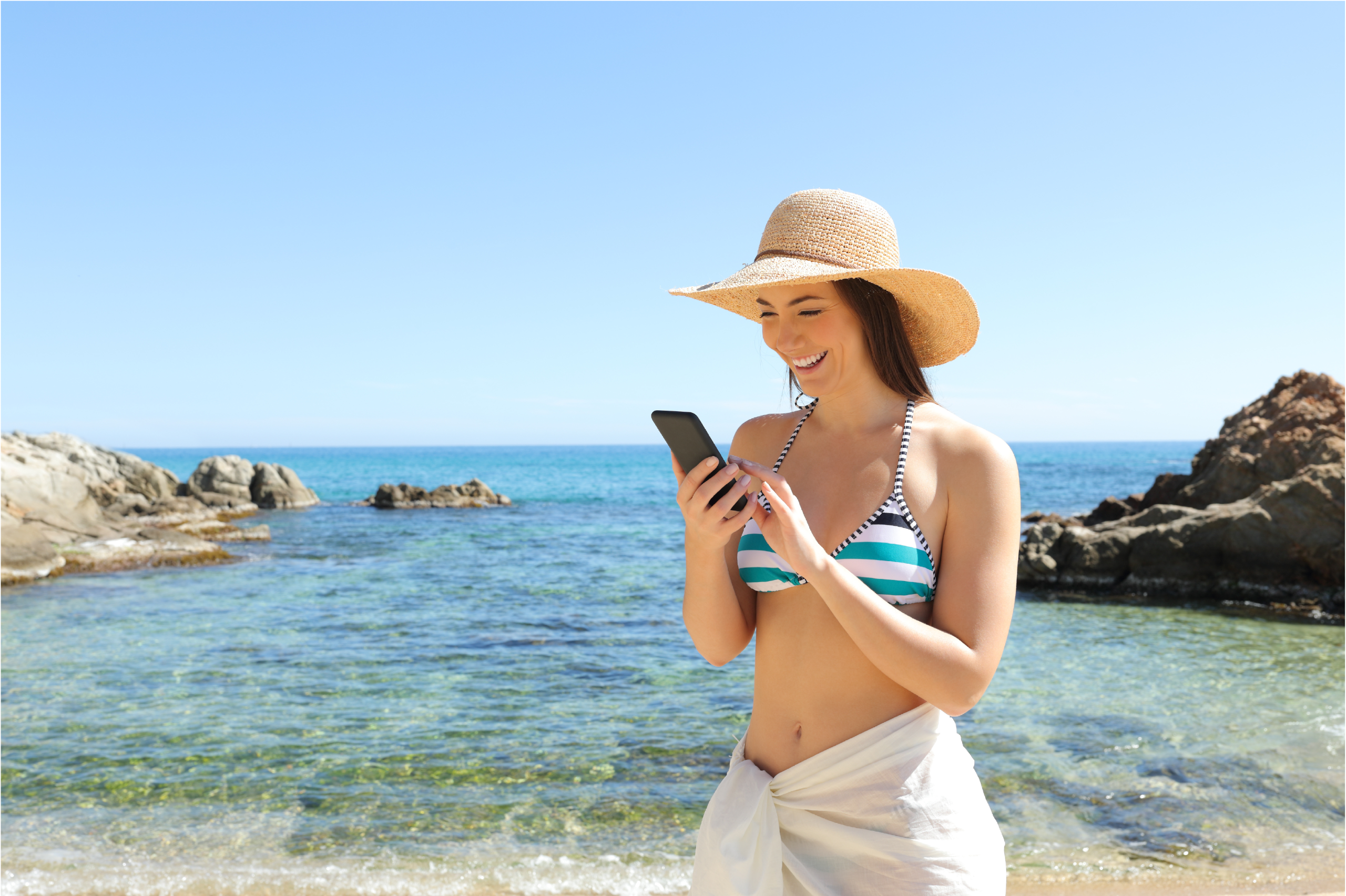 eSIM woman on a beach